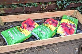Bags of soil in a raised bed Bags of soil in a raised bed