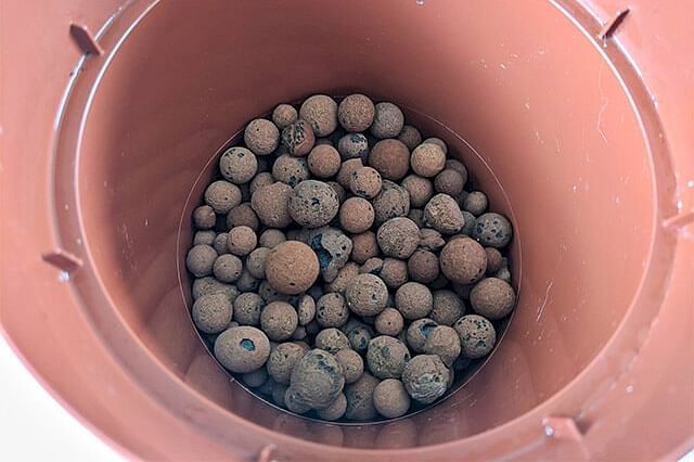Base layer of Leca in a nursery pot