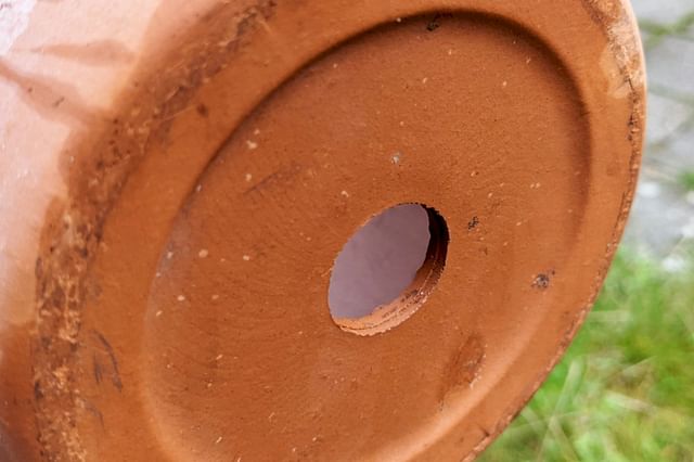 Drainage hole in a terracotta pot
