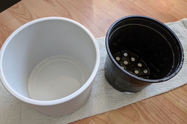 A clean plastic pot with drainage holes