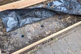 Placing rain pipes in the clay for drainage Placing rain pipes in the clay for drainage