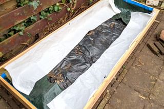 Building a raised bed with plastic lining to protect the wood Building a raised bed with plastic lining to protect the wood